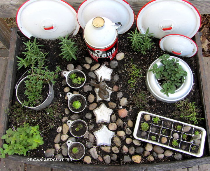 another kitchen fairy garden, gardening, I used an ice cube tray jello molds a Rumford baking powder tin funnel measuring cups and old pot lids The fence is butter knives All vintage