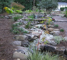 professional pond builders perspective on a backyard pond makeover in before during, outdoor living, ponds water features, Twisting turning giving some creative sight lines to the stream formation