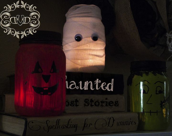three fun luminaries from mason jars, seasonal holiday decor, Stacked on a bunch of books they look fun together