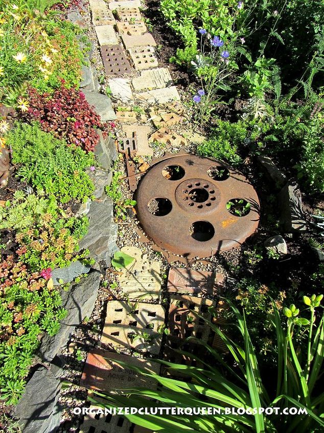 using salvaged brick in the flower border, flowers, gardening, repurposing upcycling, Interesting metal junk is included in the brick path