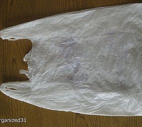 how to fold plastic shopping bags to take up less space, cleaning tips, Lay the bag out on a flat surface Line up the sides of the bag and smooth out any big wrinkles
