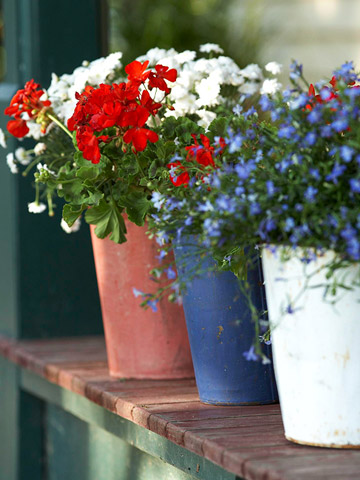 annual memorial day party prep, outdoor living, patriotic decor ideas, seasonal holiday decor, I have tons of planters all over the property and grabbing the patriotic ones won t take long I plan to scatter them out along the entertainment area and again no extra money spent