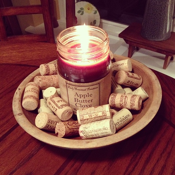 fall decor ideas, seasonal holiday decor, It s the simplistic decor I love like this apple butter candle coupled with some wine corks in a gorgeous blue antique bowl