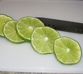 how to make ice luminaries, outdoor living, seasonal holiday decor, Slice up some limes or maybe some lemons