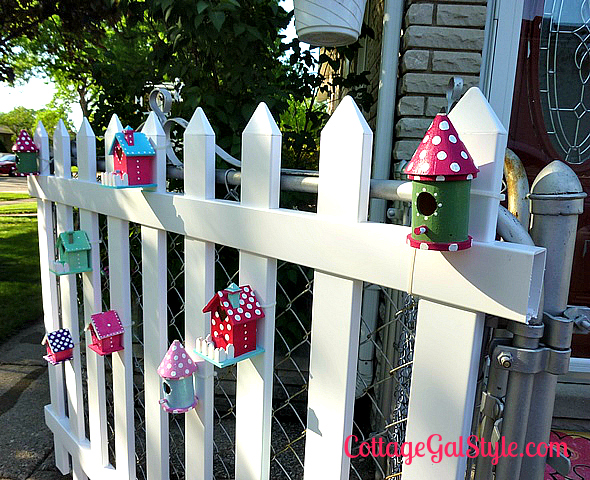 birdhouses dress up a plain picket fence
