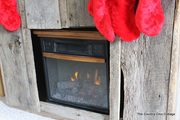 barnwood christmas mantel, fireplaces mantels, seasonal holiday d cor, The electric fireplace nestled inside