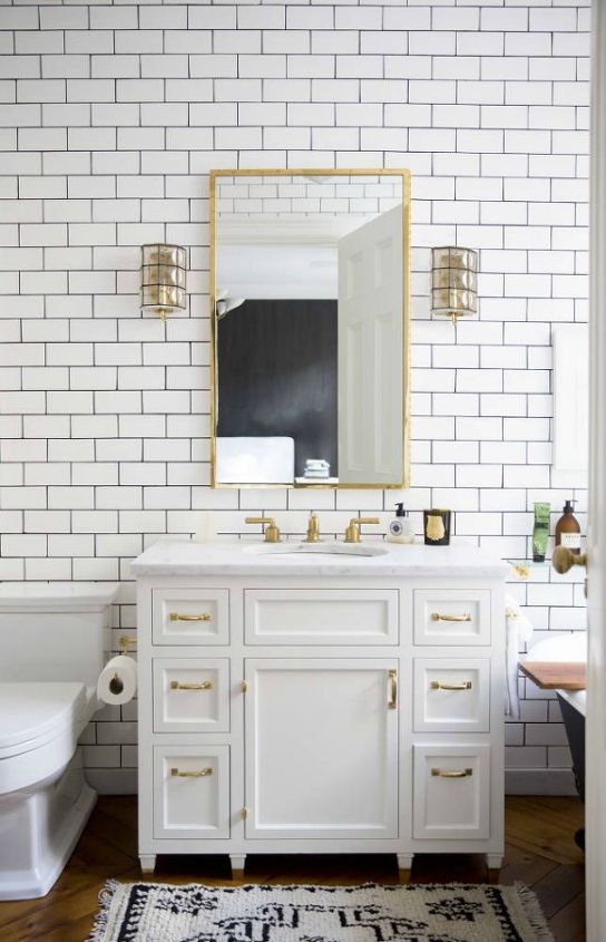 trend watch gold hardware, bathroom ideas, home decor, kitchen cabinets, kitchen design, painted furniture, Gold and white is a trendy color combination and this bathroom exemplifies why Gold hardware ties in nicely with the gold faucet and lighting and breaks up the white on white of the subway tile Photo Source