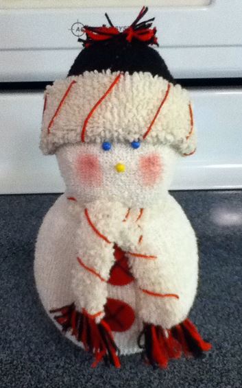 sock snow people, crafts, seasonal holiday decor, The scarf is a strip of the sock cut off stretched and tied on I added the red stripes with embrodery floss The tassels are also embrodery floss while the hat is the toe part of an insulated sock
