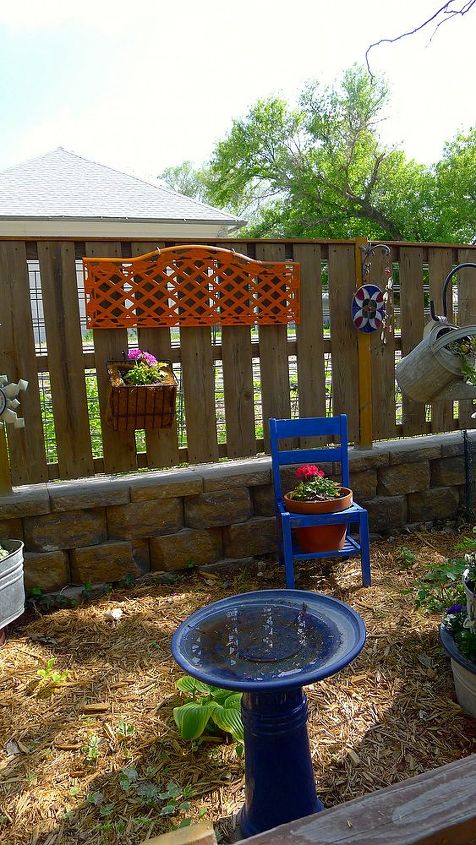 beginning to look like spring, The iron work on the fence is a bit of an old bench I moved this chair into this area and added a bicycle basket planter on the fence