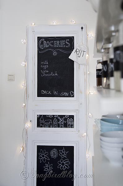 kitchen organization with a chalk board vintage door, chalkboard paint, crafts, diy, home decor, kitchen design, repurposing upcycling, The door is leaning against the wall but safely secured with screws Some little lights add some whimsey and a pretty light at night