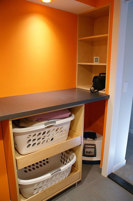 a functional laundry room, This is the folding station and storage You can also find a place for the cats litter box in here