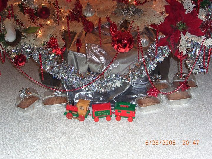 we did a red white and sliver christmas enjoy the color scheme throughout my home, christmas decorations, seasonal holiday decor, Home made breads and gifts for my guests with a wooden train under the tree