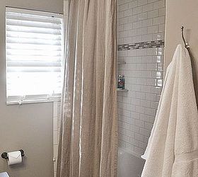 1964 bathroom makeover, bathroom ideas, home decor, We used basic subway tile with and accent strip And we also used a curved shower curtain rod and an extra long shower curtain to add the illusion of height to the room