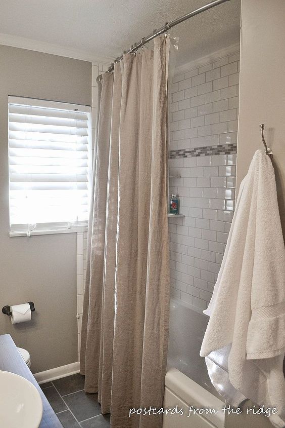 1964 bathroom makeover, bathroom ideas, home decor, We used basic subway tile with and accent strip And we also used a curved shower curtain rod and an extra long shower curtain to add the illusion of height to the room