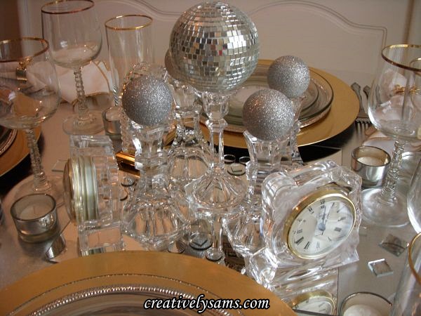 new year s tablescape, seasonal holiday decor, Centerpiece I started with a 12 square mirror then added crystal candle holders I added a small mirrored disco ball to the tallest candle holder silver glitter ornaments to the other ones I used small mirrors as scatter silver tea light holders with white tea lights