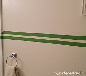 painting horizontal stripes on a wall, painting, Once you ve drawn the even line or dots with your pencil start laying the tape edge with the line