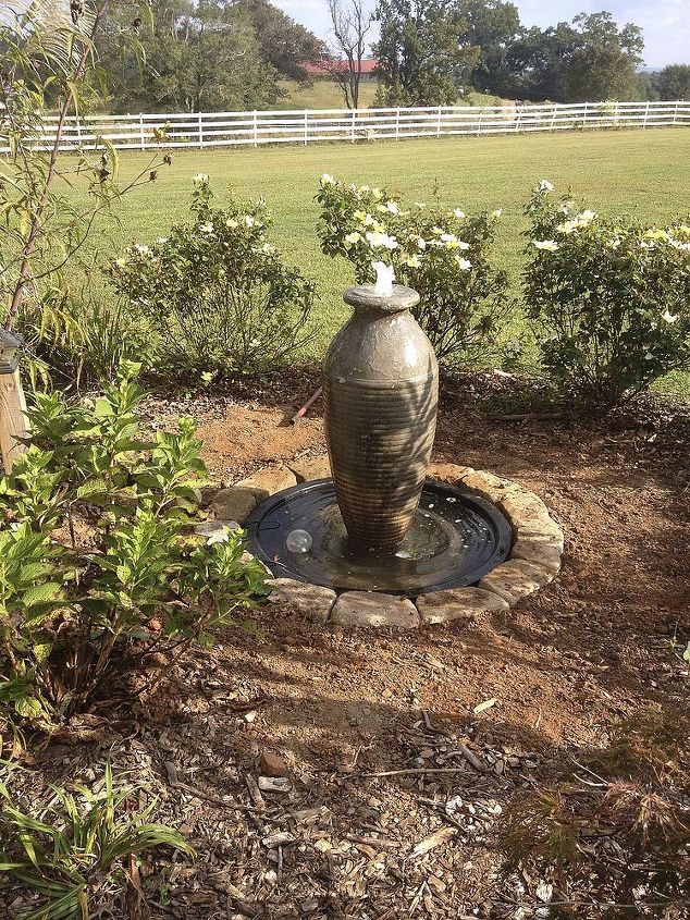 new project new and improved water feature, landscape, outdoor living, ponds water features, Basin installed leveled new pump added and urn placed and leveled and basin filled Stones placed around the basin and the power cord connected The final result