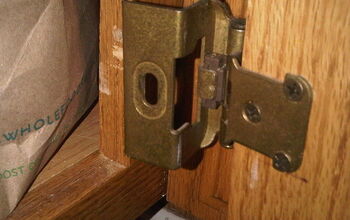 Fixing cabinet hinges.