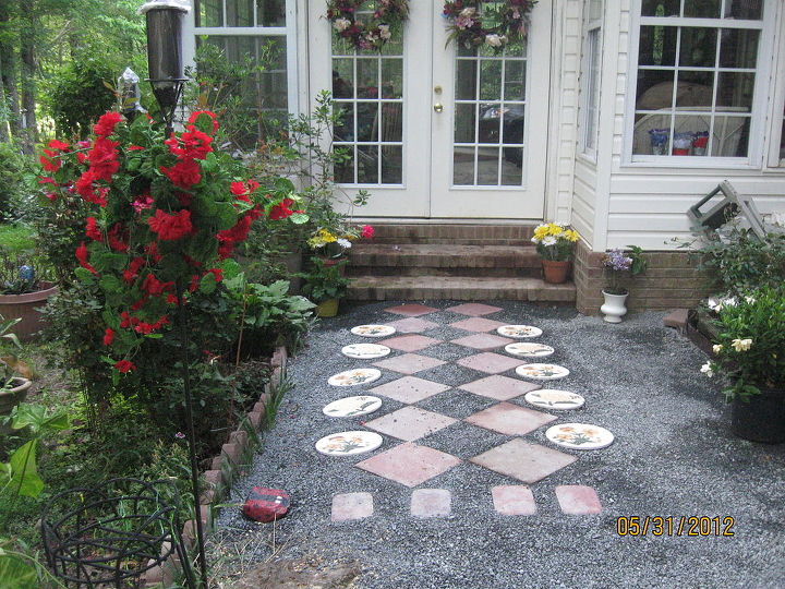 found the answer to how to put tile on a concrete floor, concrete masonry, flooring, tile flooring, tiling, New walkway to the sunroom Helps to keep dirt and mud out of the sunroom The squares was left over from the new front walkway and the round ones I bought 15 years ago and never used them They just stayed piled up at the barn 3 projects finished This walkway on the right side is edged with brown aluminum edging