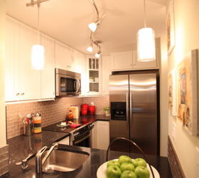remodeling a small space is surely a challenge this 575 square foot condominium is, home decor, kitchen design, storage ideas, urban living, This kitchen is all of 8 x 6 and has all full size appliances Every inch of space is used and has added significant storage