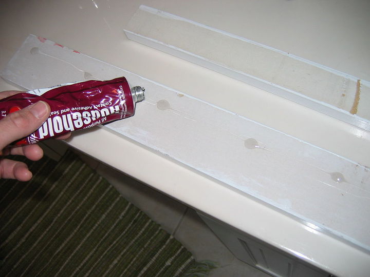 revamp that large bathroom mirror, bathroom ideas, home decor, Used GOOP adhesive to position MDF on mirror front It was held in place by tape until it dried