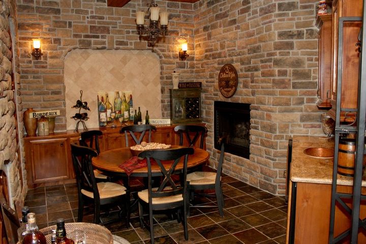 wine grotto meet wine room, fireplaces mantels, home decor, Not only richly detailed with stone surround but accented nicely with fireplace 1 of 5 in the home full wet bar with wine refrigerator and hammered copper sink basin but chandelier and custom mill working