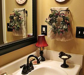 my french country guest bath, bathroom ideas, home decor, A mirror and fixtures in oil rubbed bronze continue the French country look I added a small wreath to the towel rack for a little bit of Christmas along with another plate