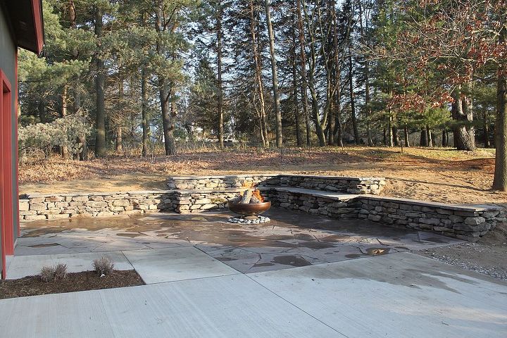 stone wall and patio with fire pit, outdoor living, patio, Natural stone wall and patio with fire pit Ypsilanti MI A great shot of the very first fire with the very northern feel in the background