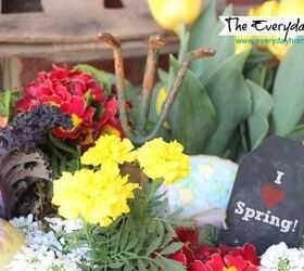 a southern porch reveal for spring 2014, curb appeal, flowers, gardening, porches, seasonal holiday decor, wreaths, A vintage red wire basket holds an assortment of Spring flowers and plants as well as a small chalkboard label and a vintage garden tool