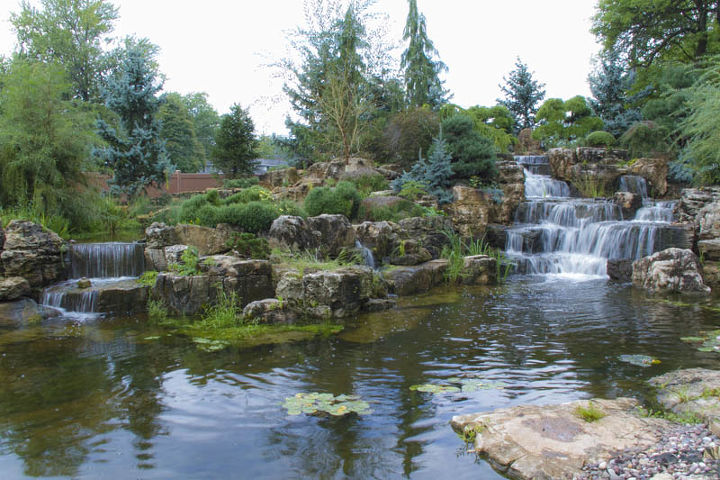 expansive waterfalls and pond in crown point indiana, outdoor living, patio, ponds water features, The main pond receives approximately 120 000 gallons of water per hour from the large waterfall to the right