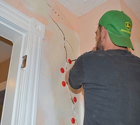 how to repair a large crack in plaster, diy, home maintenance repairs, how to, wall decor, Installing plaster washers using a 2 inch drywall screws into some of the holes