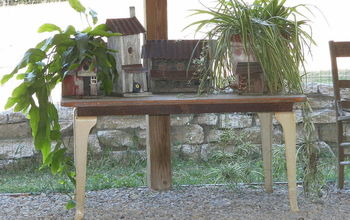 Plant table made from legs off of an old wood cook stove