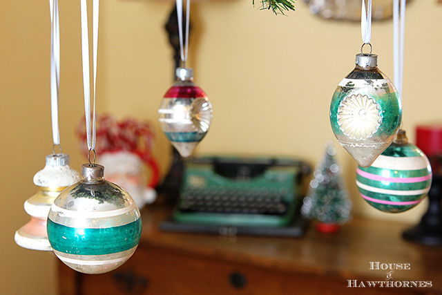 fun retro christmas dining room tour, christmas decorations, seasonal holiday decor, Shiny Brites hanging from ribbons on my chandelier