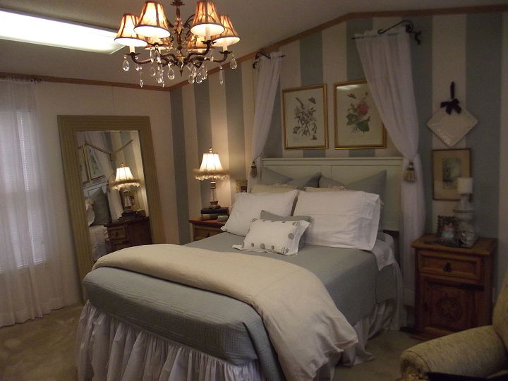 downsizing texas winter home, bedroom ideas, home decor, The floor length mirror was actually a bathroom mirror that someone removed I framed it and wired a curtain tie back thru the holes that were used to hang the mirror I love it it reflects light and makes the room look much larger