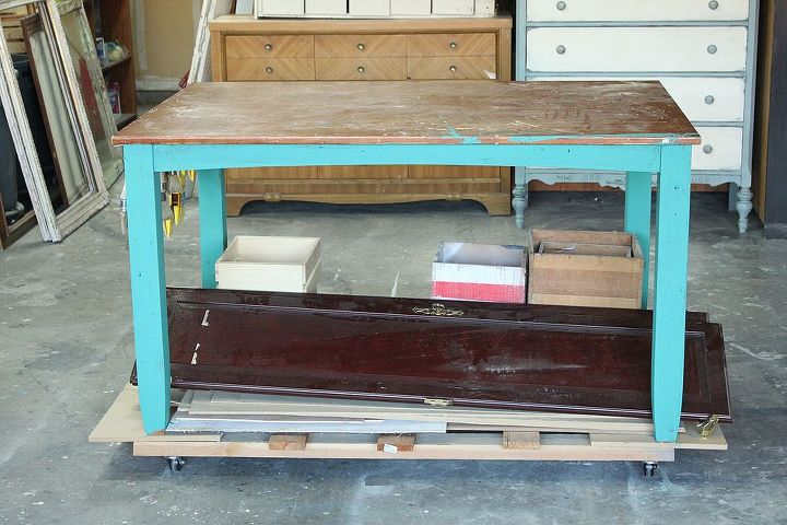 dining table turned rolling work table, painted furniture, repurposing upcycling, Painted the legs in a combination of CeCe Caldwell s Emeral Isle and Maine Harbor Blue for the perfect dark Turquoise Now it is a fun work table too