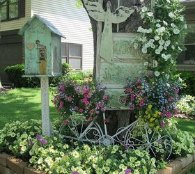 vintage summer garden, flowers, gardening, outdoor living, repurposing upcycling, I used another old vintage potting shed door and hung it on my tree The birdhouse is also sitting on an old chippy post The old metal bike is another fun way to put potted plants in the garden