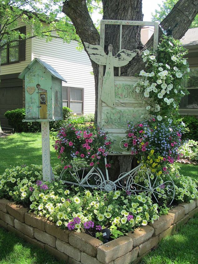 vintage summer garden, flowers, gardening, outdoor living, repurposing upcycling, I used another old vintage potting shed door and hung it on my tree The birdhouse is also sitting on an old chippy post The old metal bike is another fun way to put potted plants in the garden