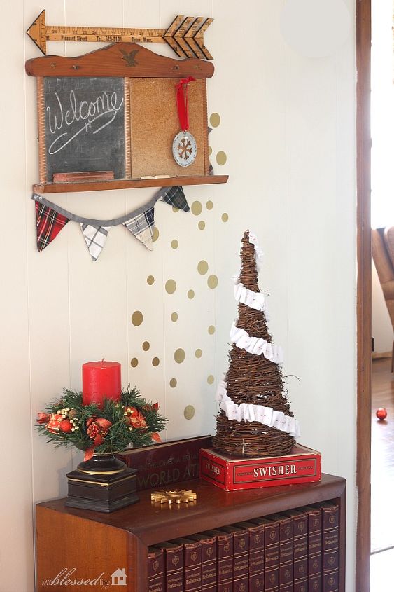 woodsy glam christmas home tour, christmas decorations, seasonal holiday decor, wreaths, The set of encyclopedias and little chalkboard corkboard have been in this place forever The encyclopedias are now my dad s but I m storing them for him I love decorating with my old cigar box The colors are so festive