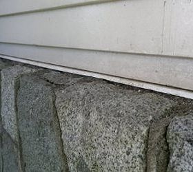 protecting junction siding meets stone wall, vertical siding comes down to meet top surface of granite stone wall