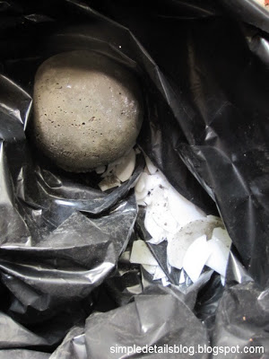 diy concrete garden spheres, concrete masonry, gardening, Using safety glasses and gloves enclose the lighting globes in a heavy duty trash bag and lightly tap with a hammer loosening the glass from the concrete Carefully dispose of the garbage bag and broken glass
