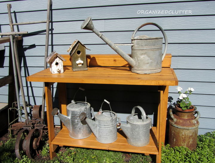 more outdoor garden junk decor, gardening, outdoor living, repurposing upcycling, Here is the narrow folding workbench with watering cans and birdhouses
