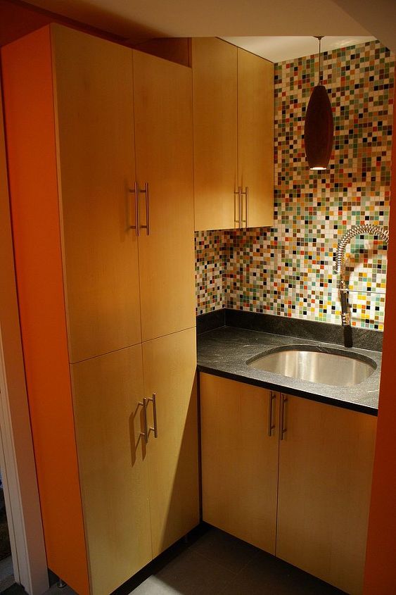 a functional laundry room, sitting on custom made maple vanity is a leathered piece of jet mist granite The faucet and sink are that of a commercial kitchen The oak pendant is from the local lighting store and I m not sure of it s origin The colorful mosaic is from modwalls
