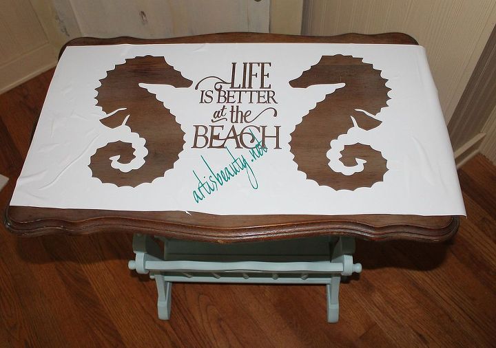 sea horse beachy magazine rack end table makeover, painted furniture, transferring the vinyl stencil to the table top and painting