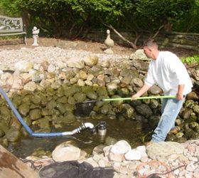 ecosystem pond maintenace spring pond or water garden maintenance tip, home maintenance repairs, outdoor living, ponds water features, First drain the pond down to a few inches and pump some of the water into a storage tank for the fish Now we can catch the fish more easily place them in the tank and cover them up This is a good time to check your pond lighting