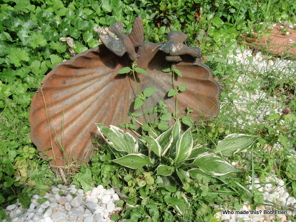 junk birdbath becomes garden statuary, gardening, outdoor living, repurposing upcycling, The bird bath in its new home surrounded by beauty