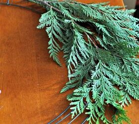 diy rustic cedar bough wreath, christmas decorations, crafts, seasonal holiday decor, wreaths, Let the boughs naturally guide their position on the form they have a curve to them that you need to go with Don t fight it