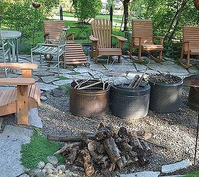 our pennsylvania bluestone patio gets a face lift, diy, patio, tiling, We do love our yard for dining out this is our less formal patio firepit Notice the old washing machine drums They make excellent firepits because the holes add to good circulation heat comes out the holes