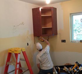 how we re making mom s remodel dreams come true, countertops, flooring, home improvement, kitchen backsplash, kitchen cabinets, kitchen design, tile flooring, The first cabinet going up