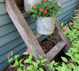re purposed tree house ladder, container gardening, gardening, repurposing upcycling, I had my husband add a rubber pad to the top rung and side posts to protect the siding He also put a large nail in two of the rungs to keep the buckets in place One of the bucket bottom holes slides over the nail
