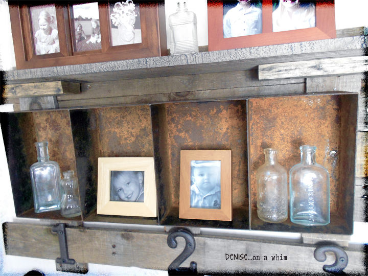 a rusty bin and pallet wood shelf, diy, how to, living room ideas, pallet, shelving ideas, woodworking projects, The metal bin is a shelf itself perfect for holding smaller photos and items like these vintage glass bottles